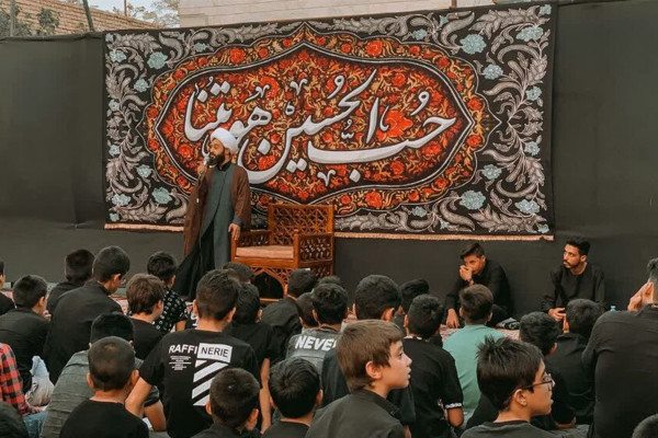 همراه با هیئت «قاسم ابن الحسن» که دانش‌آموزان را برای امور فرهنگی کنار هم جمع کرده است